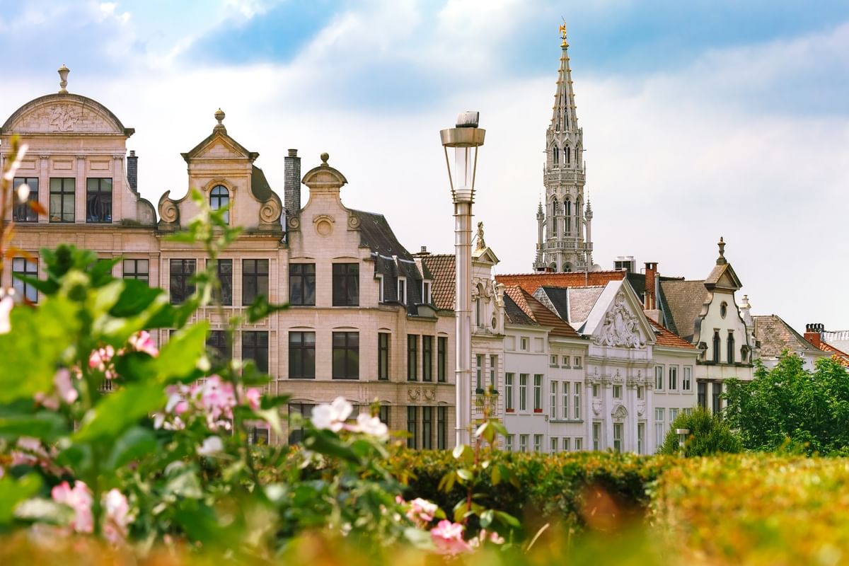 View of the Brussels Town Hall spire rising above city rooftops near Hotel Barsey by Warwick