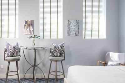 A table & two chairs in Double Queen Blue Bayou at Retro Suites