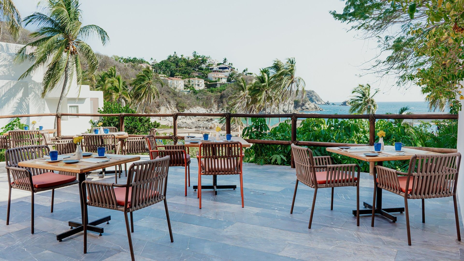 Outdoor terrace dining area with greenery and ocean views in Chez Binni at Camino Real Zaashila Huatulco