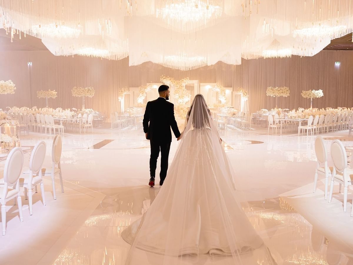 Paris and Daniel entering the wedding hall with floral decor at Crown Towers Perth