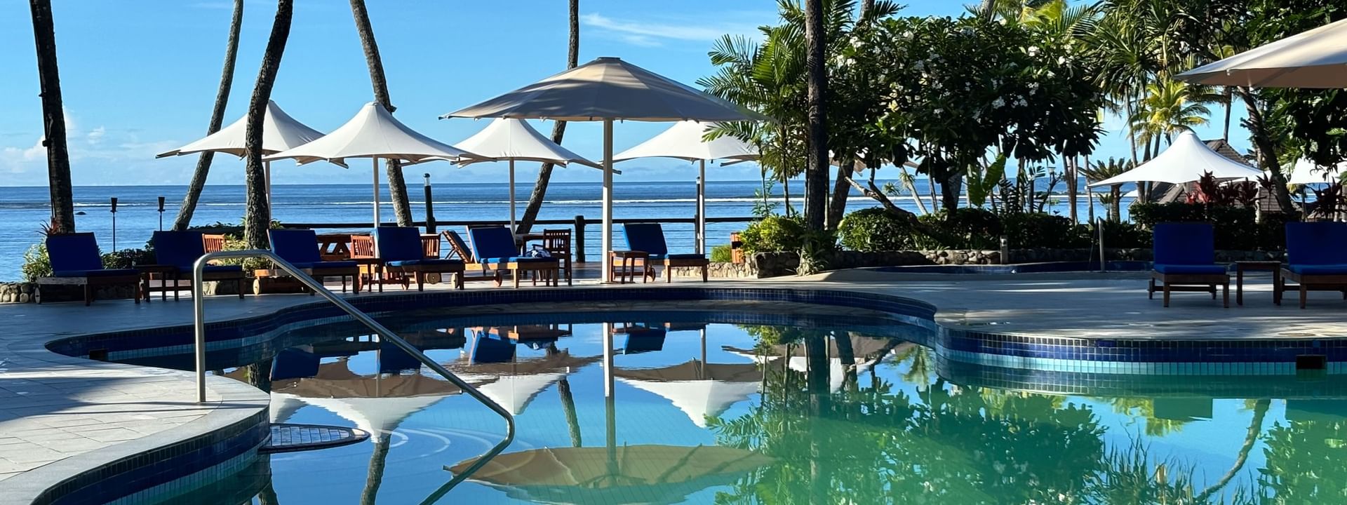 Blue swimming pool with ocean view at Warwick Fiji Resort and Spa, Korolevu