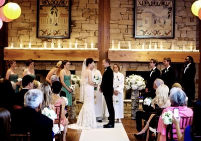 Bride & groom taking vows by the aisle at Stein Eriksen Lodge