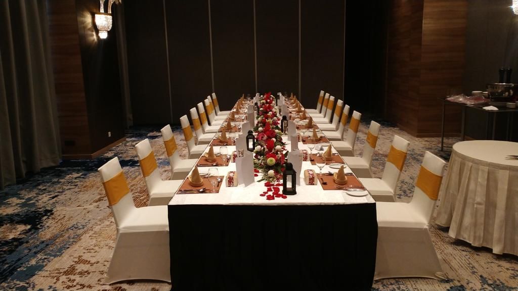 Long dining table arranged with white chairs at Sunway Hotel Big Box