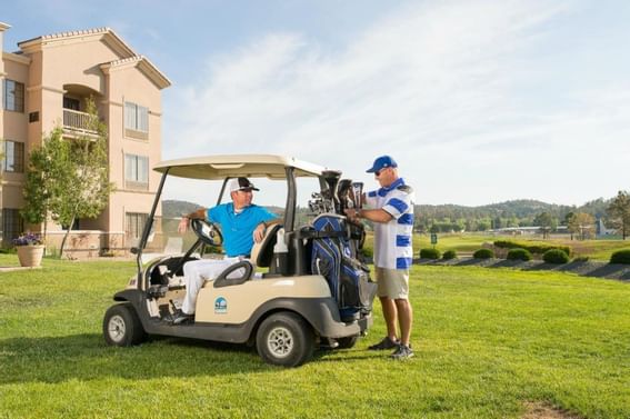 Two men are getting ready to play golf at MCM Elegante Ruidoso