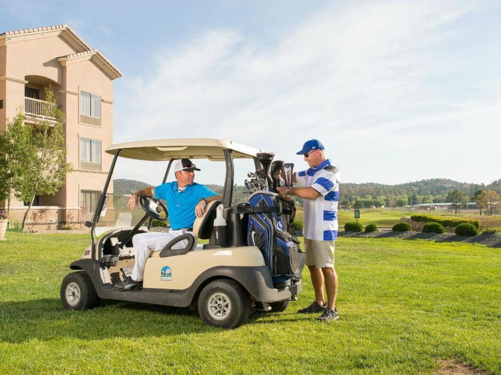 Two men are getting ready to play golf at MCM Elegante Ruidoso
