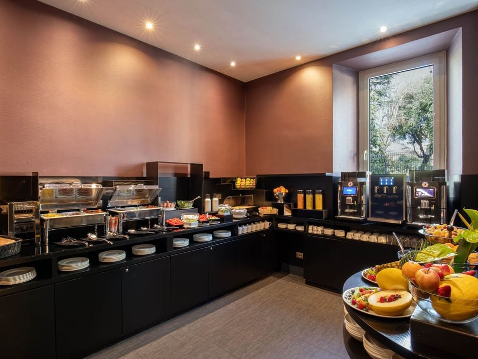 Modern Breakfast restaurant at The Guardian Hotel featuring fresh fruits, salads, beverage dispensers, and soft lighting