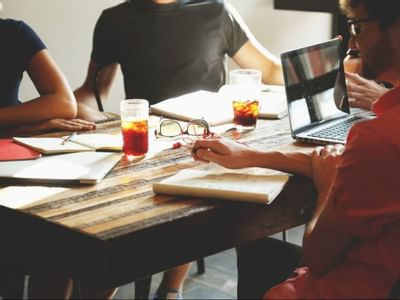 A group of young professionals collaborating around a table in a bright workspace at The Paramount Hotel Seattle