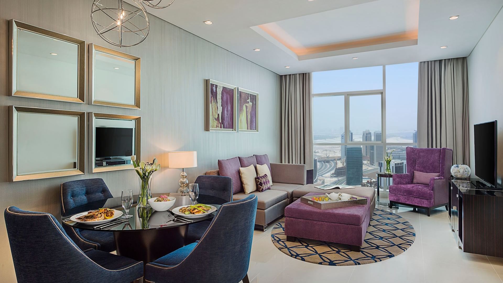 Spacious living area with dining table by the kitchenette in One Bedroom Suite at DAMAC Maison Distinction