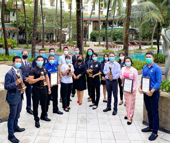 Staff holding awards at Chatrium Royal Lake Yangon