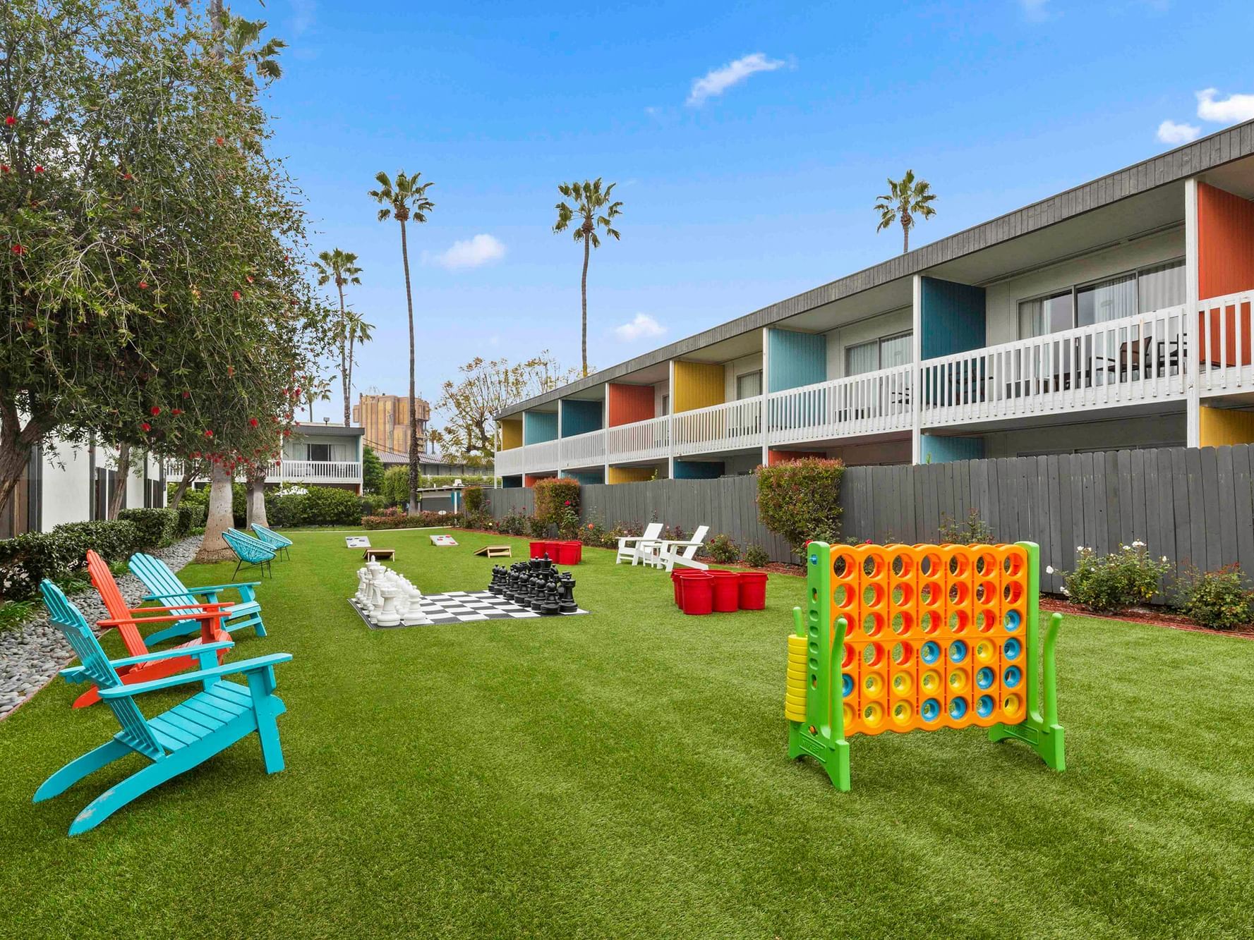 outdoor grassy play area with oversized games and chairs