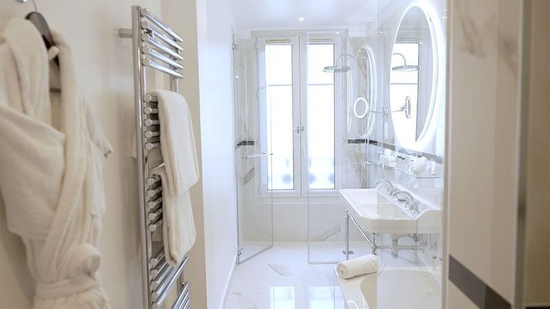 Interior of Prestige Suite bathroom with mirrored sink and marble surface at Hôtel Westminster - Paris