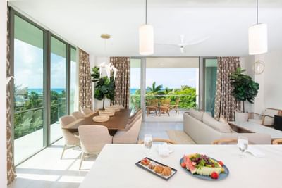 Dining table by the window, featuring a lounge and balcony seating in the S202 Room at The Residences at Seafire