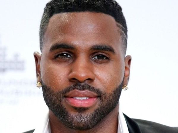 Portrait of Jason Derulo at Pullman East Melbourne, with short, styled dark hair, a neatly trimmed beard, and stud earrings