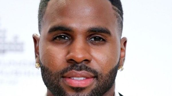 Portrait of Jason Derulo at Pullman East Melbourne, with short, styled dark hair, a neatly trimmed beard, and stud earrings