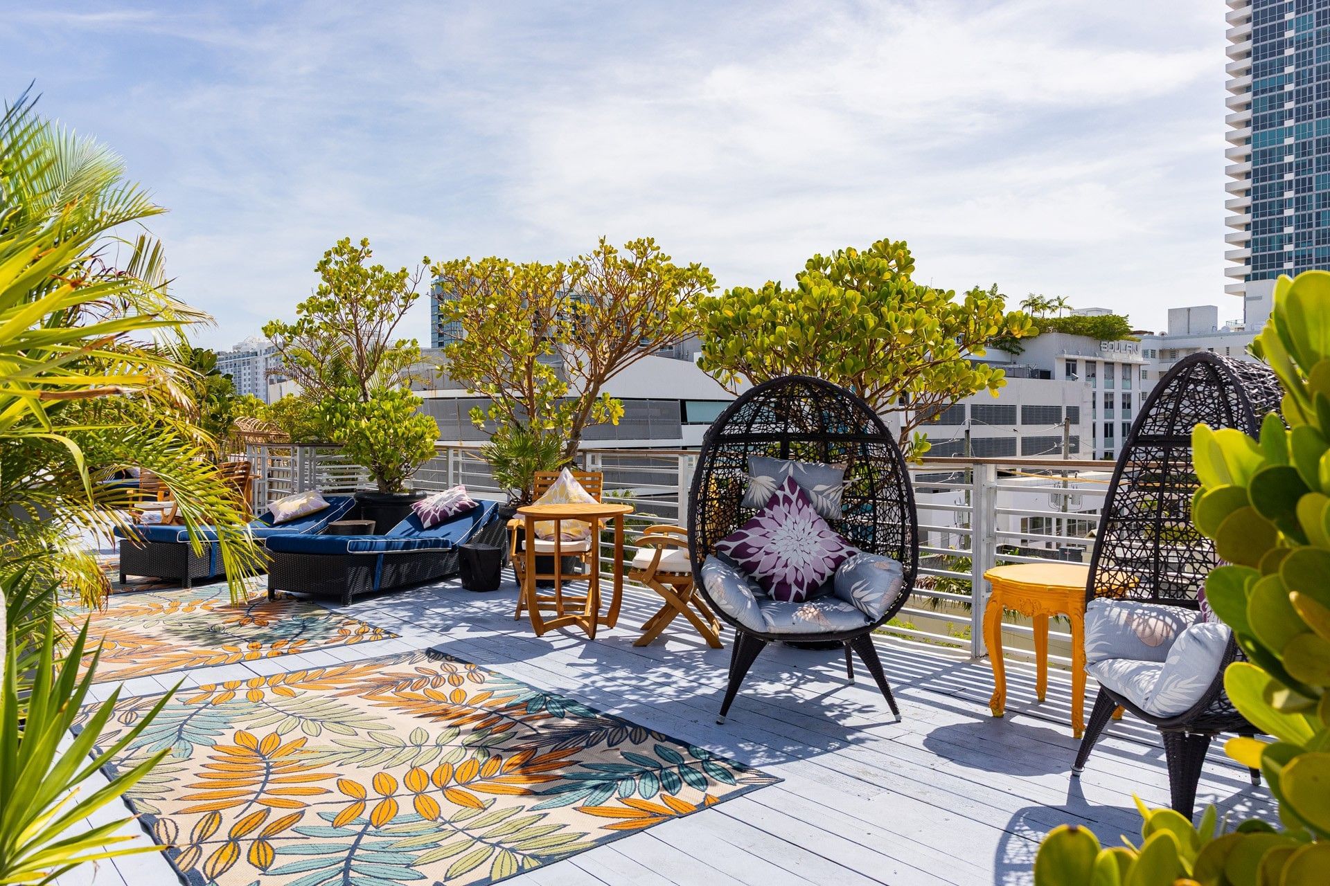 A rooftop lounge with outdoor seating and city view