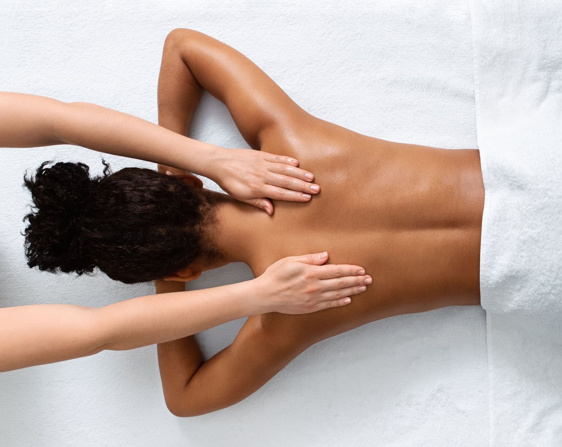Top-down view of a therapist giving a relaxing back massage to a guest at Vita Spa in El Conquistador Resort