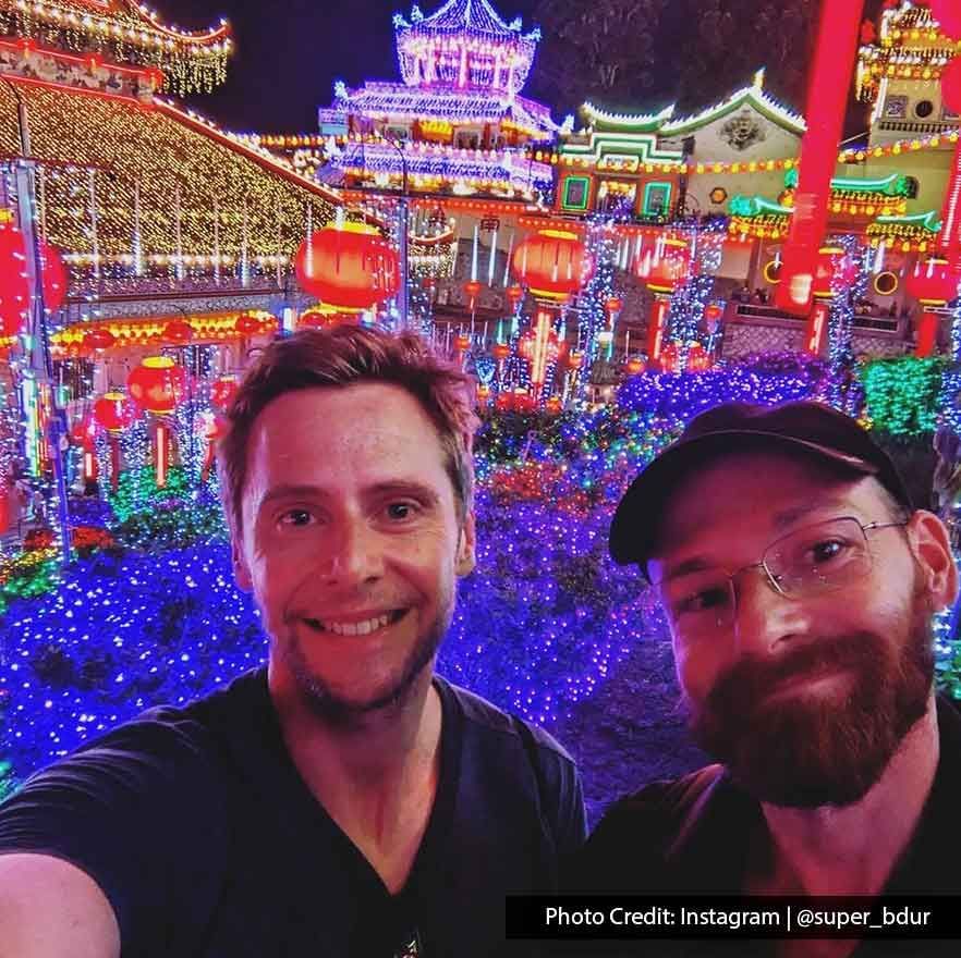 Two tourists were taking a selfie inside the Kek Lok Si temple at night - Lexis Suites Penang