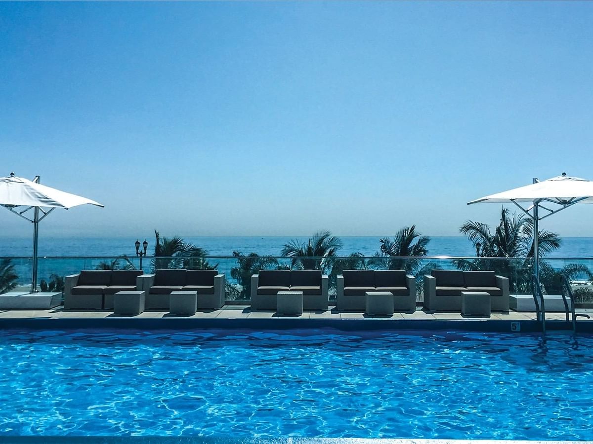 Patio umbrellas & pool beds by the outdoor pool at Ocean Place