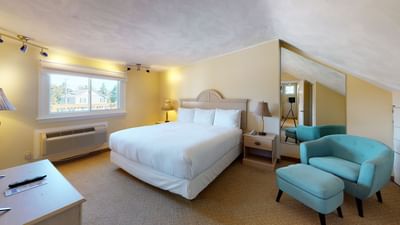 Bed with table lamp by the window and couch in Main House Two Bedroom at Breezeway Boutique Hotel