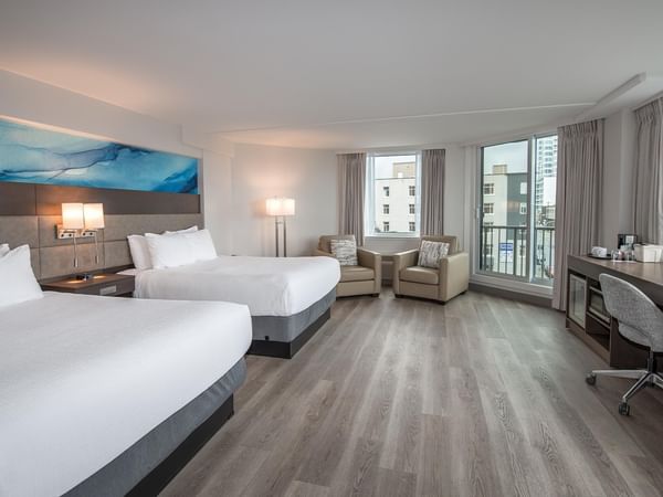 Two queen beds, desk, and balcony in Coast Premium Two Queens with Ocean View at Coast Bastion Hotel in Nanaimo.