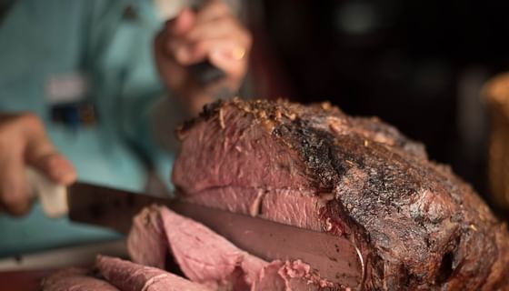Man cutting a massive roast beef  at The Landing Hotel 