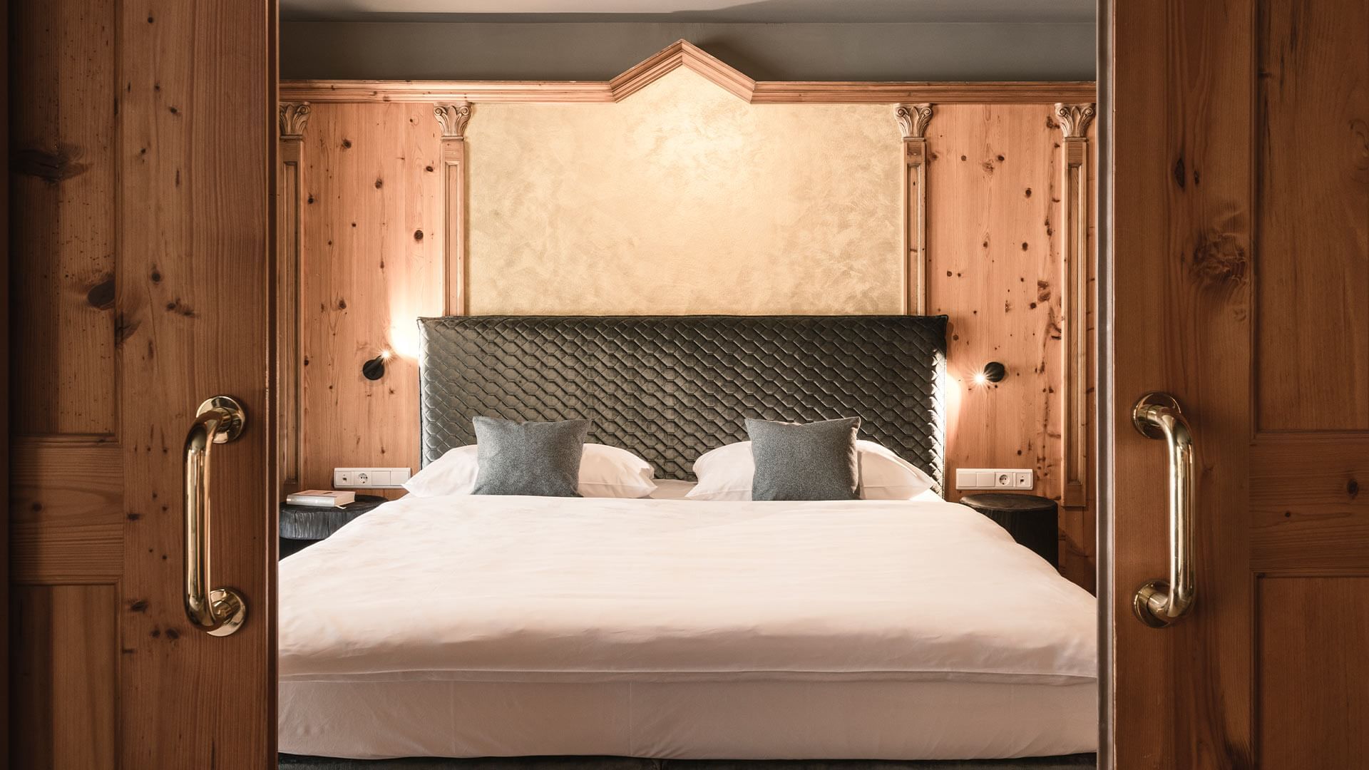 Bed with headboard in Romantic Suite at Falkensteiner Hotels