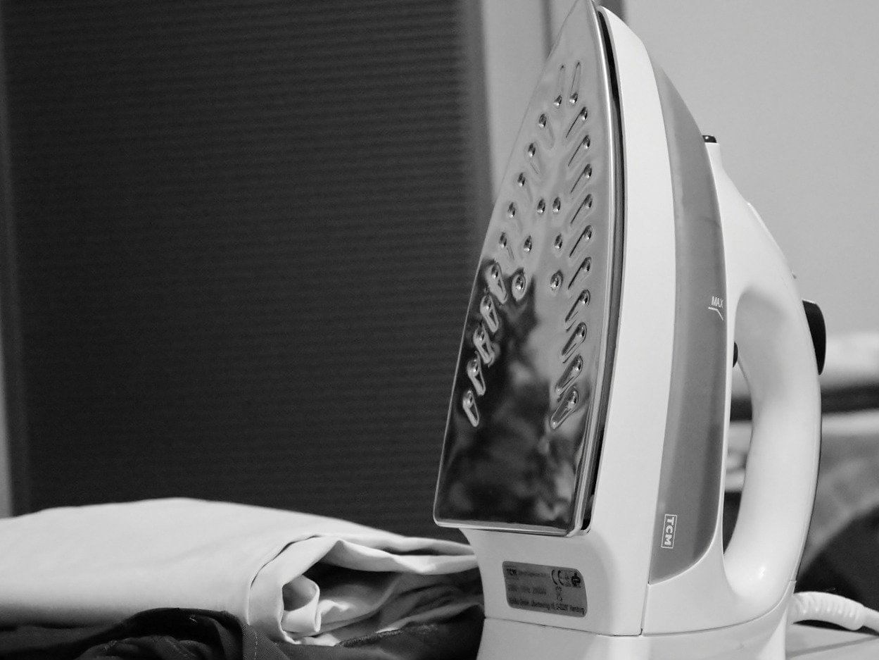 An iron on an ironing board at Rheinland Hotel Kollektion