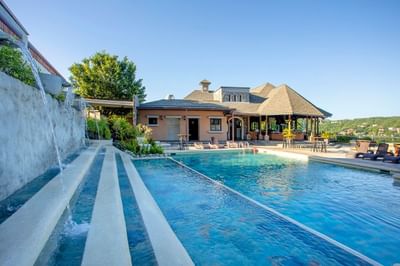 An outdoor pool with arranged sun loungers at Villas Sol Beach Resort