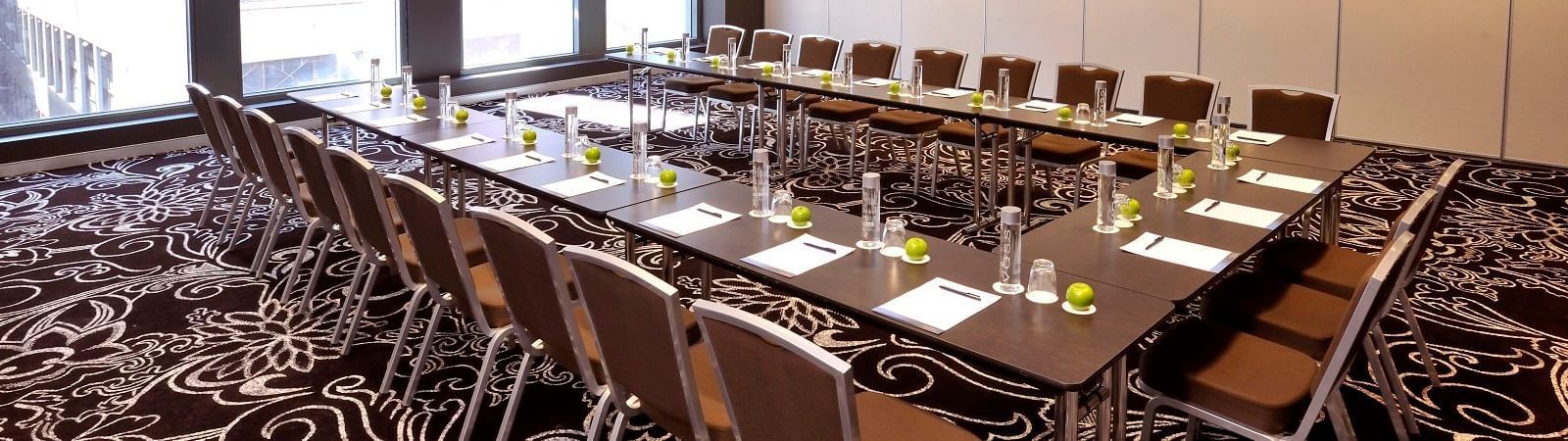 U-shaped table setup for meeting at Novotel Melbourne