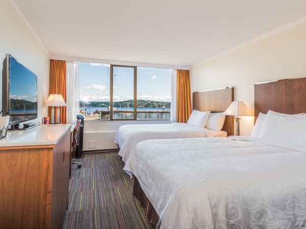 Two beds in hotel room with ocean view
