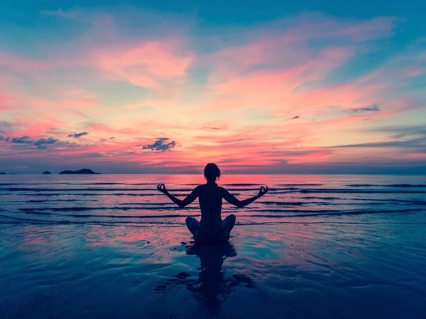 A silhouette of a lady meditating at Daydream Island Resort