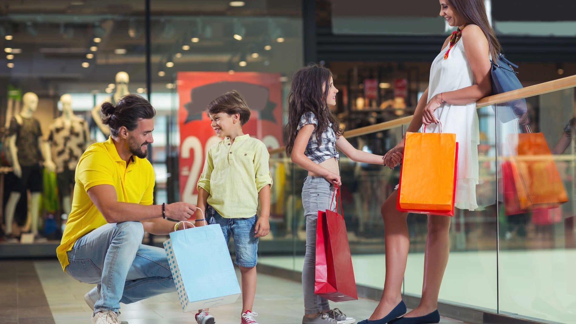 Happy family with shopping bags enjoying a day out at a bright modern Perisur mall near Camino Real Pedregal Mexico