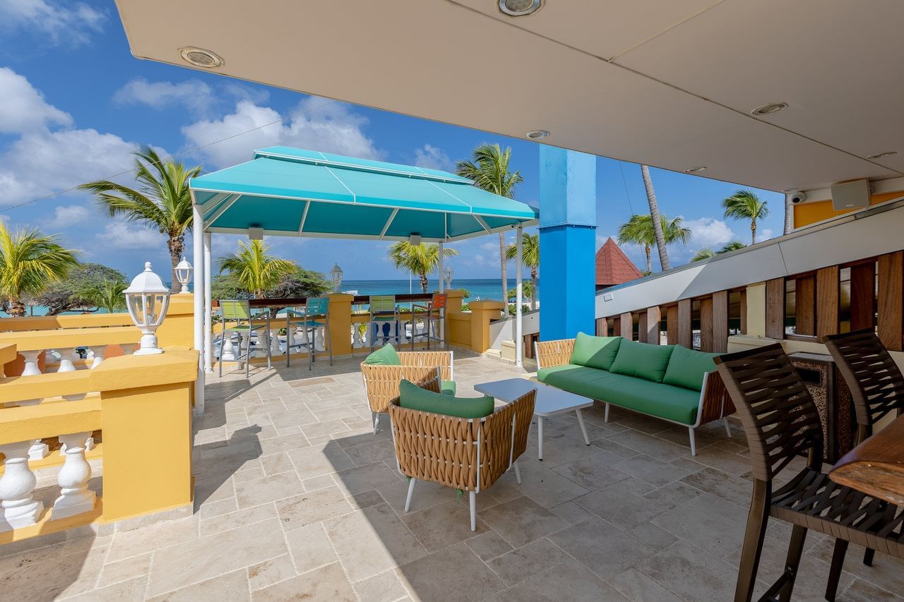 Outdoor patio with interior at Amsterdam Manor Beach Resort Aruba
