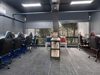A gaming room with rows of gaming stations and monitors at La Trobe University Menzies College.