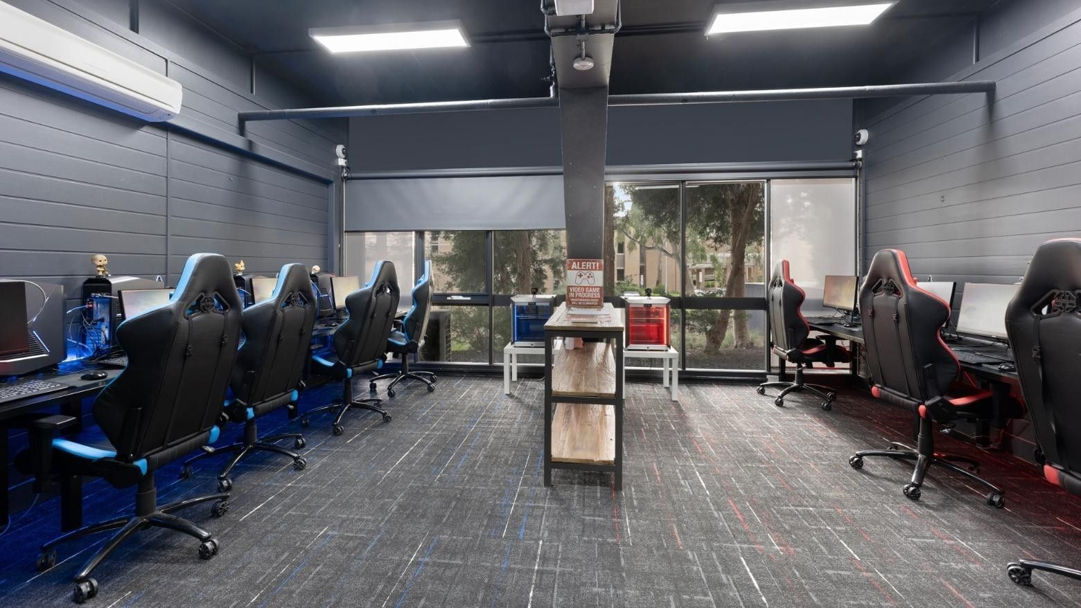 A gaming room with rows of gaming stations and monitors at La Trobe University Menzies College.