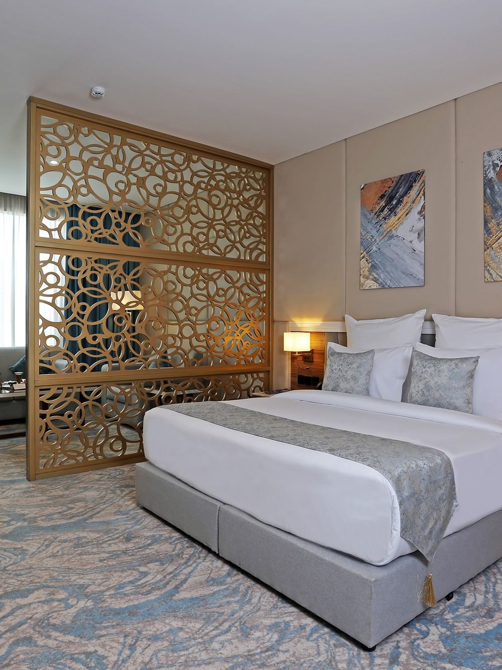 Elegantly decorated Junior Suite with large bed and modern decor at Cantonal Hotel by Warwick Riyadh.