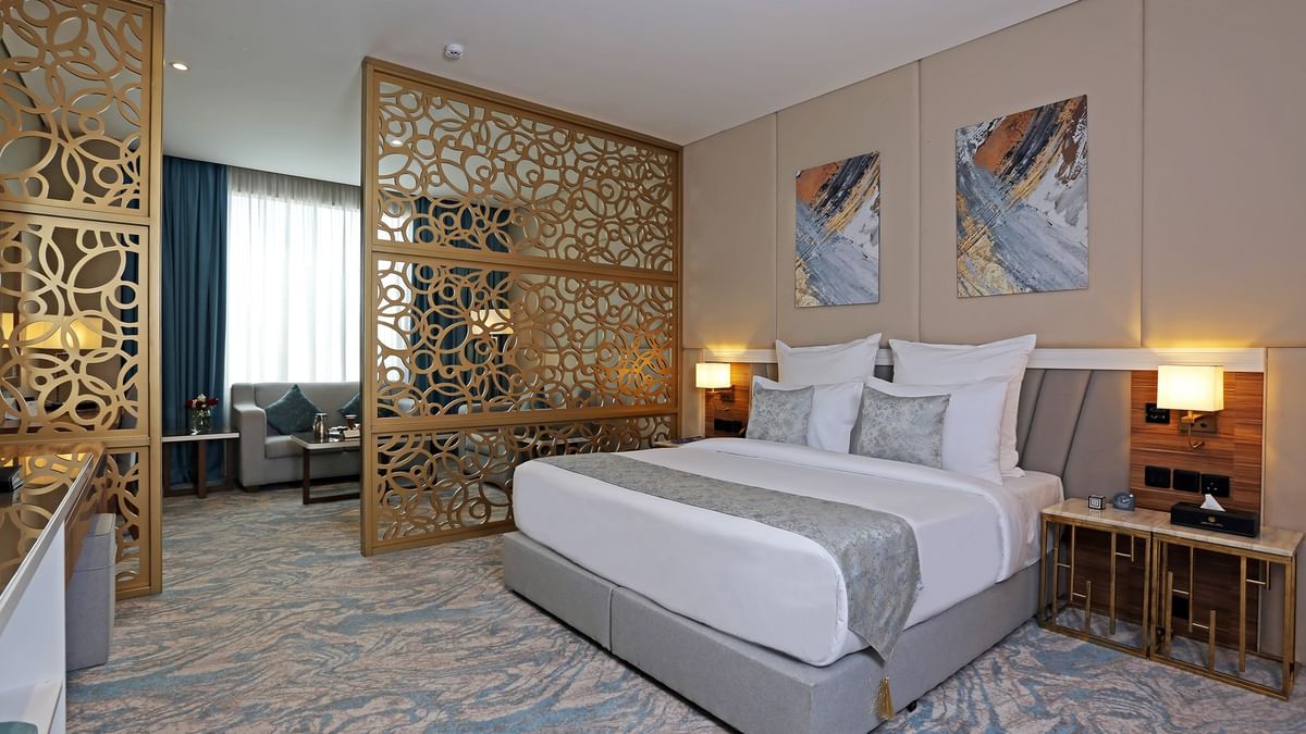Elegantly decorated Junior Suite with large bed and modern decor at Cantonal Hotel by Warwick Riyadh.