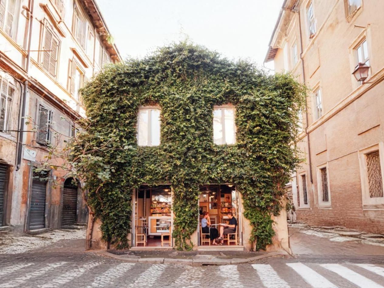 Scenic view of charming ivy-covered La Casetta a Monti bar, tucked between narrow streets near The Independent