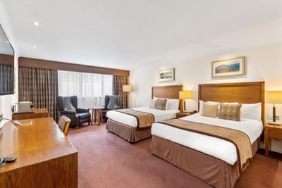 Premium Family Room with two comfortable beds and two arm chairs at The Aberdeen Altens Hotel