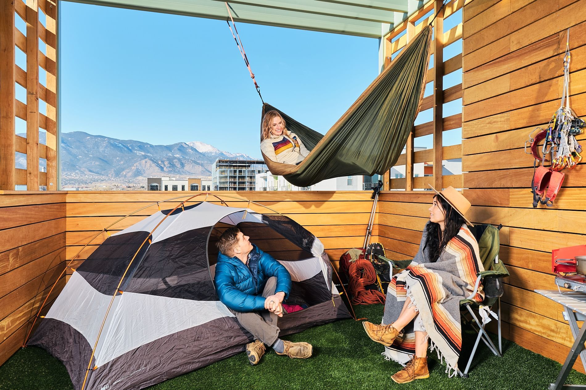 Three people enjoying in the Camp Deck at Kinship Landing