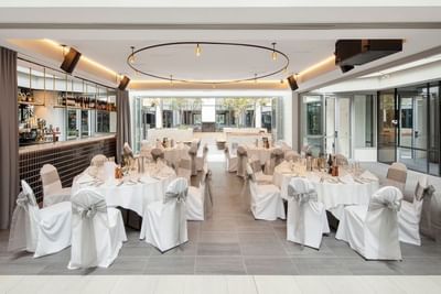 Event Pavilion with banquet set-up, sleek bar, and modern lighting at Amora Herencia Riverwalk Melbourne
