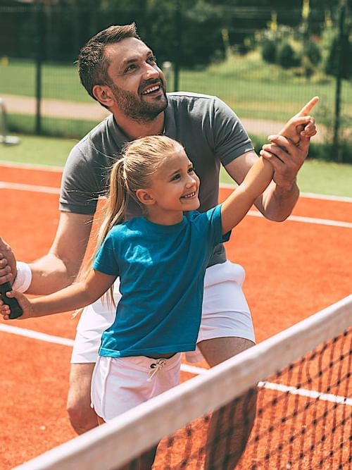 Father and daughter playing tennis at Mundo Imperial