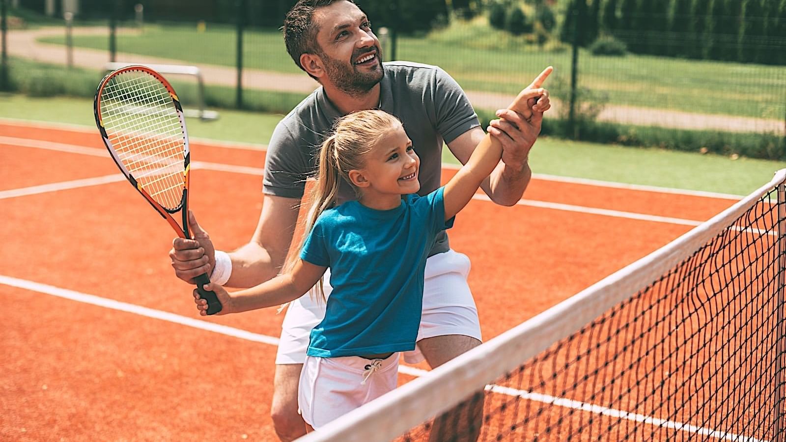 Father and daughter playing tennis at Pierre Mundo Imperial