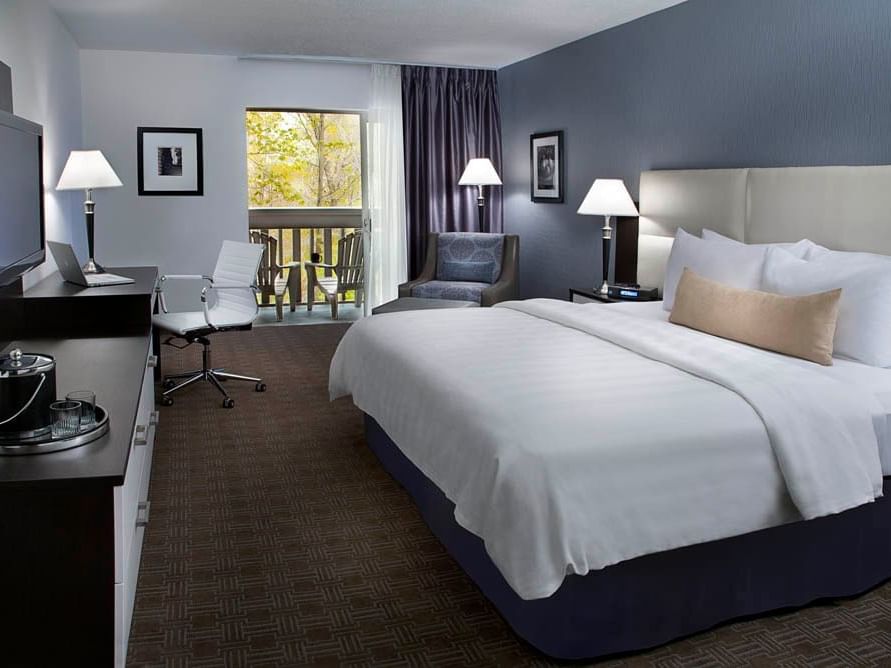 a bed facing a tv in a hotel room