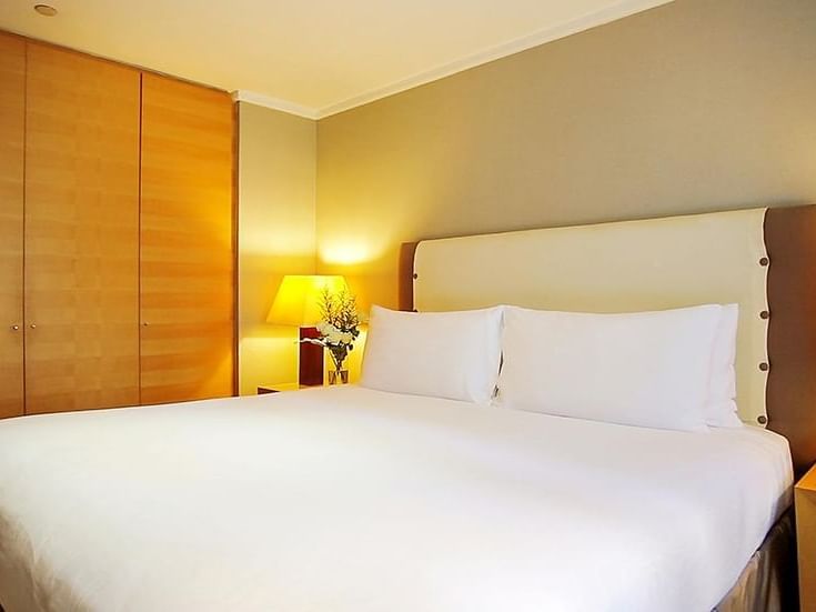 Deluxe room interior with large bed at Amara Hotel Singapore
