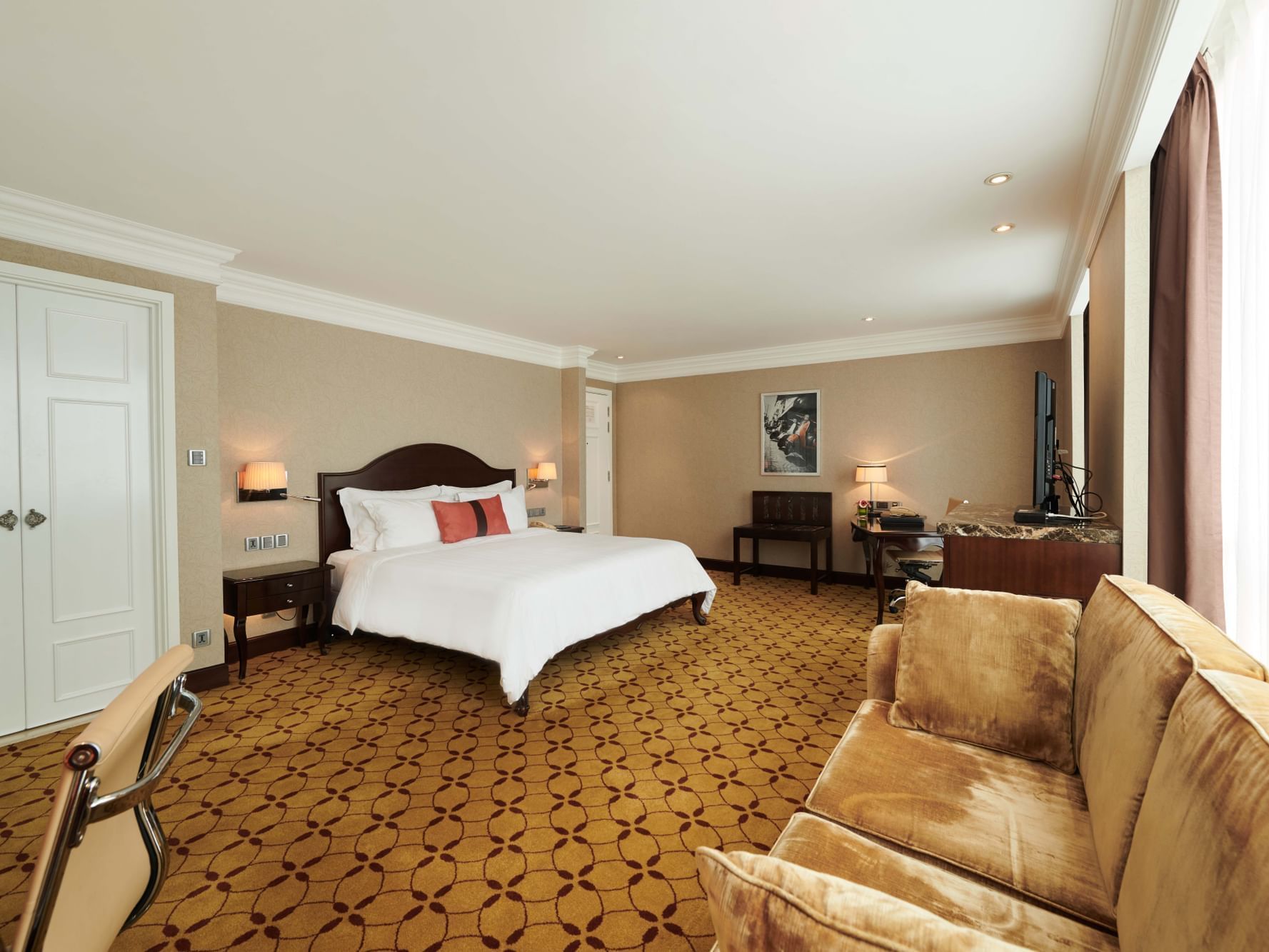 Family Deluxe Room with a king size bed, TV & a comfy sofa at Eastin Grand Hotel Saigon