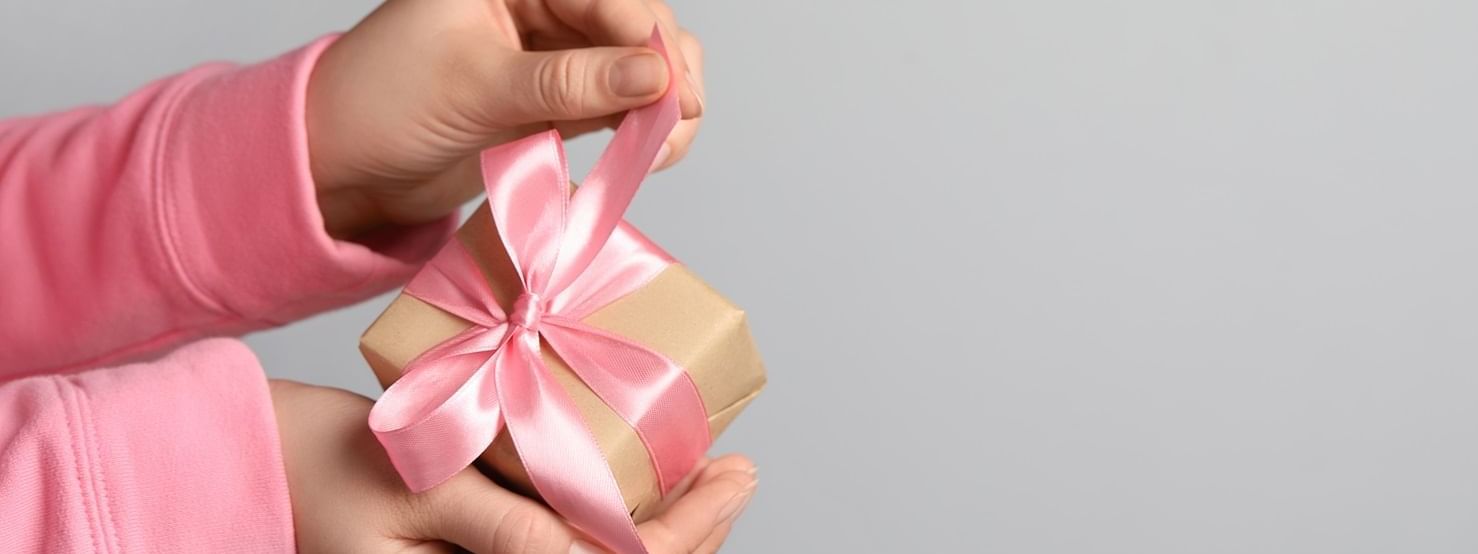 Hand unwrapping a gift box