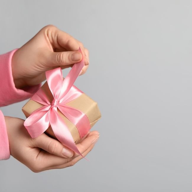 Hand unwrapping a gift box