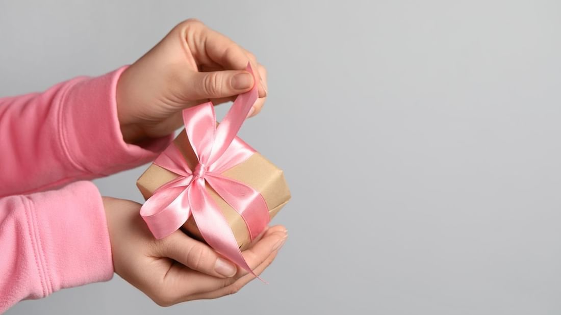 Hand unwrapping a gift box