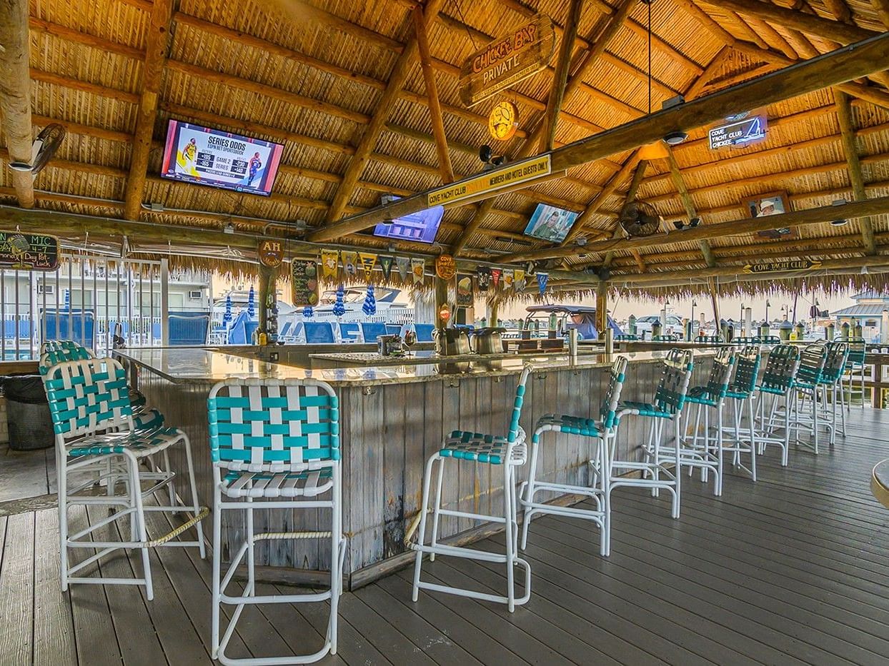 Empty Chickee Bar with stools at the bar at Cove Inn at Naples Bay.